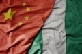 big waving national colorful flag of china and national flag of nigeria Royalty Free Stock Photo