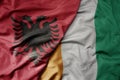 big waving national colorful flag of cote divoire and national flag of albania