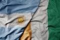 big waving national colorful flag of cote divoire and national flag of argentina