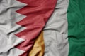 big waving national colorful flag of cote divoire and national flag of bahrain