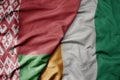 big waving national colorful flag of cote divoire and national flag of belarus