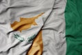 big waving national colorful flag of cote divoire and national flag of cyprus