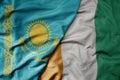 big waving national colorful flag of cote divoire and national flag of kazakhstan