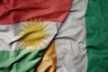 big waving national colorful flag of cote divoire and national flag of kurdistan
