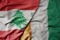 big waving national colorful flag of cote divoire and national flag of lebanon