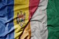big waving national colorful flag of cote divoire and national flag of moldova