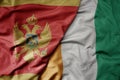 big waving national colorful flag of cote divoire and national flag of montenegro