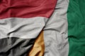 big waving national colorful flag of cote divoire and national flag of yemen