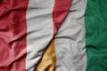 big waving national colorful flag of cote divoire and national flag of peru