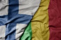 big waving national colorful flag of finland and national flag of mali