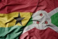 big waving national colorful flag of ghana and national flag of burundi Royalty Free Stock Photo
