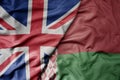 big waving national colorful flag of great britain and national flag of belarus Royalty Free Stock Photo