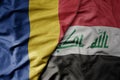 big waving national colorful flag of iraq and national flag of romania