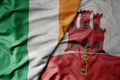 big waving national colorful flag of ireland and national flag of gibraltar Royalty Free Stock Photo