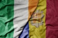 big waving national colorful flag of ireland and national flag of andorra