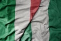 big waving national colorful flag of italy and national flag of nigeria Royalty Free Stock Photo