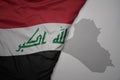 big waving national colorful flag and map of iraq on the gray background Royalty Free Stock Photo