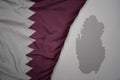 big waving national colorful flag and map of qatar on the gray background Royalty Free Stock Photo