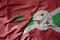 big waving national colorful flag of morocco and national flag of burundi Royalty Free Stock Photo