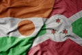 big waving national colorful flag of niger and national flag of burundi Royalty Free Stock Photo