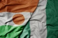 big waving national colorful flag of niger and national flag of nigeria Royalty Free Stock Photo