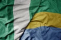 big waving national colorful flag of nigeria and national flag of gabon Royalty Free Stock Photo