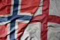 big waving national colorful flag of norway and national flag of england Royalty Free Stock Photo