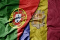 big waving national colorful flag of portugal and national flag of andorra