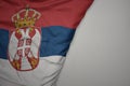 big waving national colorful flag of serbia on the gray background Royalty Free Stock Photo