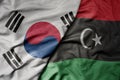 big waving national colorful flag of south korea and national flag of libya