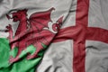 big waving national colorful flag of wales and national flag of england Royalty Free Stock Photo