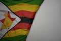 big waving national colorful flag of zimbabwe on the gray background