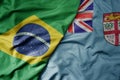 big waving realistic national colorful flag of brazil and national flag of Fiji