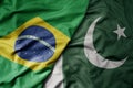 big waving realistic national colorful flag of brazil and national flag of pakistan