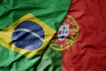 big waving realistic national colorful flag of brazil and national flag of portugal Royalty Free Stock Photo