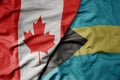 big waving realistic national colorful flag of canada and national flag of bahamas Royalty Free Stock Photo