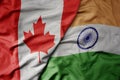 big waving realistic national colorful flag of canada and national flag of india