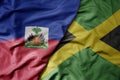 big waving realistic national colorful flag of haiti and national flag of jamaica Royalty Free Stock Photo