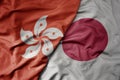 big waving realistic national colorful flag of hong kong and national flag of japan