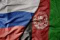 big waving realistic national colorful flag of russia and national flag of afghanistan