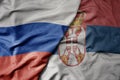 big waving realistic national colorful flag of russia and national flag of serbia