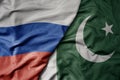 big waving realistic national colorful flag of russia and national flag of pakistan