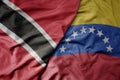 big waving realistic national colorful flag of trinidad and tobago and national flag of venezuela