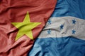 big waving realistic national colorful flag of vietnam and national flag of honduras
