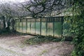 Big weathered gate at the majestic entrance to the closed territory surrounded by green nature