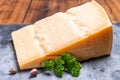 Big wedge of parmigiano-reggiano parmesan hard Italian cheese made from cow milk or Grana Padano Royalty Free Stock Photo