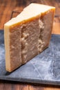 Big wedge of parmigiano-reggiano parmesan hard Italian cheese made from cow milk or Grana Padano Royalty Free Stock Photo