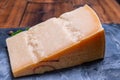 Big wedge of parmigiano-reggiano parmesan hard Italian cheese made from cow milk or Grana Padano Royalty Free Stock Photo