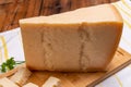 Big wedge of parmigiano-reggiano parmesan hard Italian cheese made from cow milk or Grana Padano