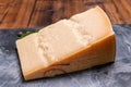 Big wedge of parmigiano-reggiano parmesan hard Italian cheese made from cow milk or Grana Padano Royalty Free Stock Photo